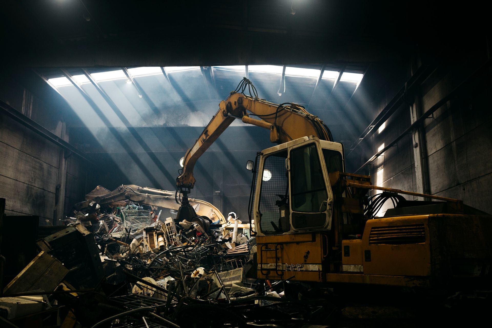 A hydraulic grabber sorting scrap metal inside the Beartown Recycling processing building