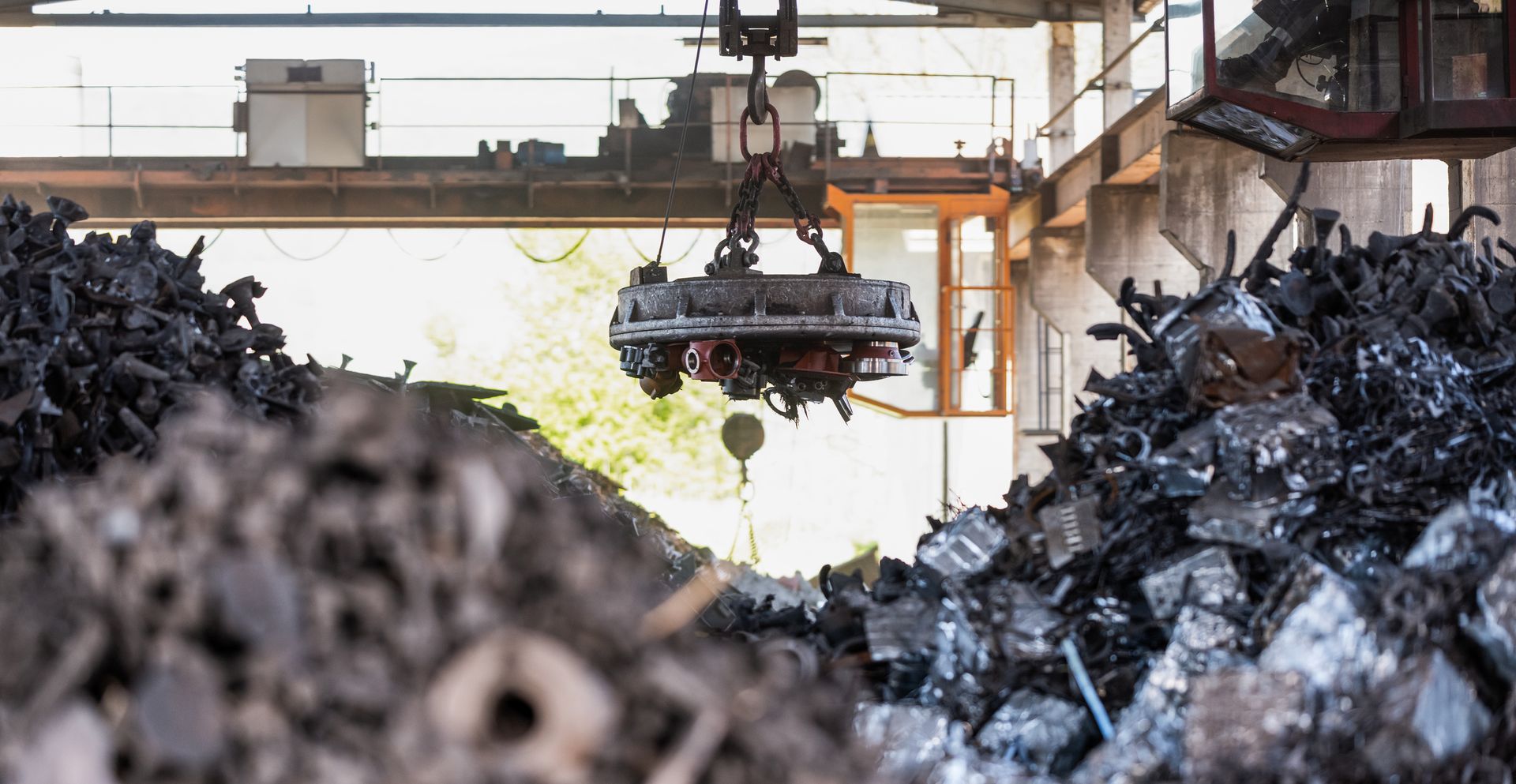 An electromagnet lifting scrap steel at the Beartown Recycling yard