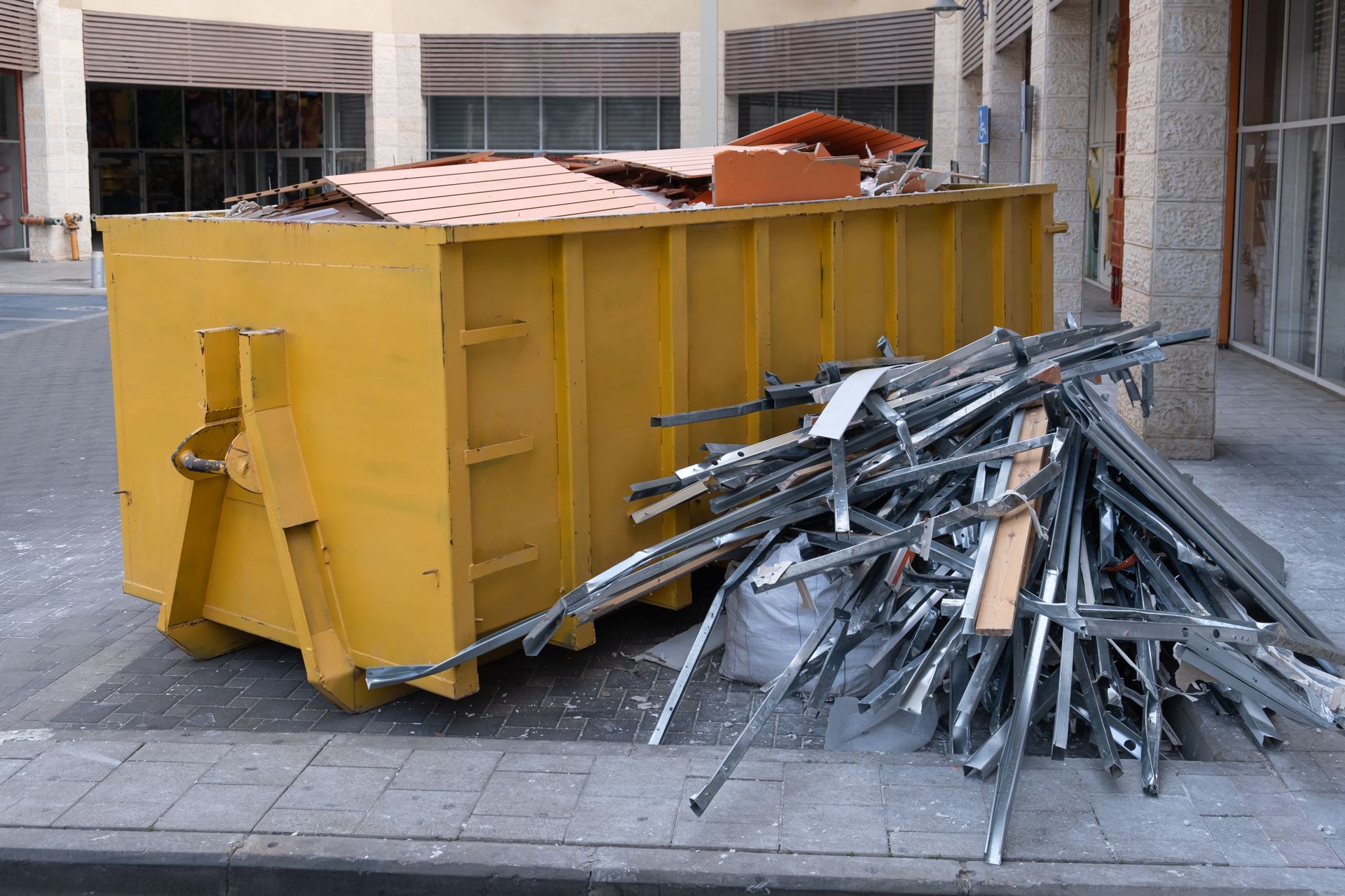A roll-off container filled with scrap metal at a job site served by Beartown Recycling